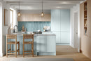 Modern kitchen with light blue cabinets, wooden stools, and a neutral color palette.