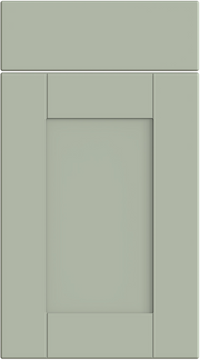 A matt sage green classic shaker style cabinet door with a simple design featuring a central panel flanked by two narrower panels, all set within a rectangular frame.