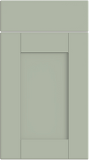 A matt sage green classic shaker style cabinet door with a simple design featuring a central panel flanked by two narrower panels, all set within a rectangular frame.